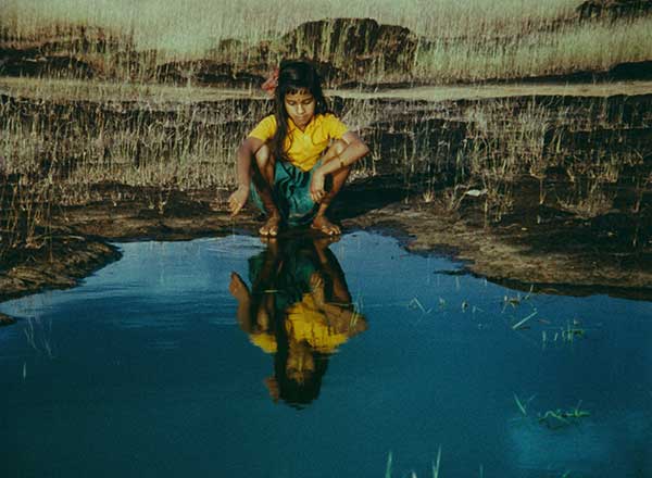 Frame from Kummatty — girl by the water
